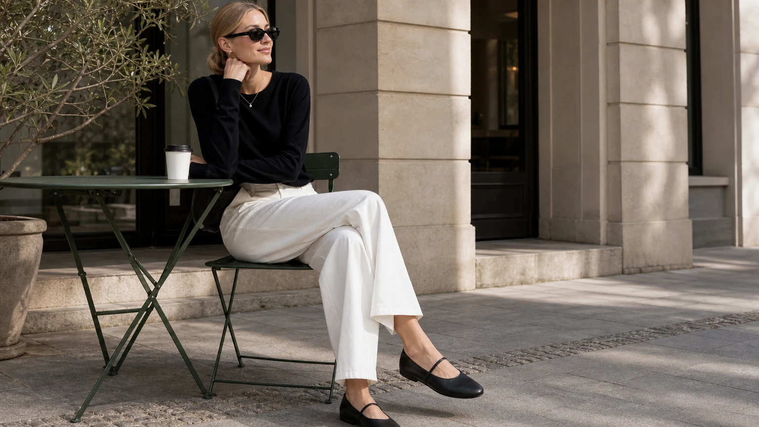 Black rounded toe Mary Jane flats styled in a horizontal lifestyle scene