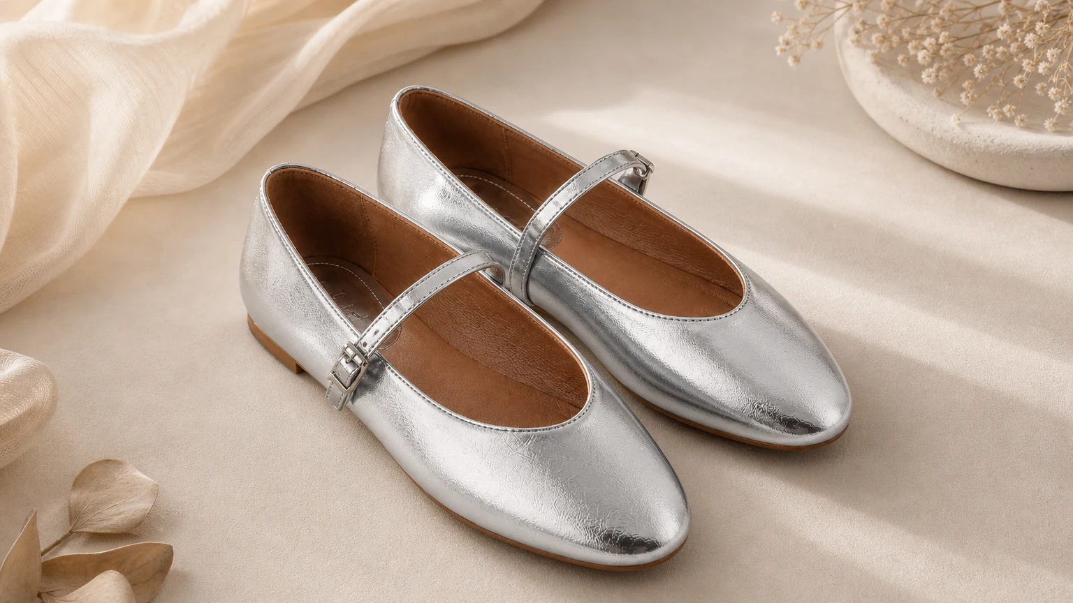 Glossy silver Mary Jane flats styled in a horizontal scene