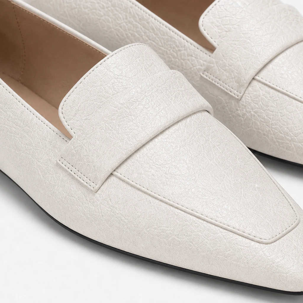 Close-up detail of glossy textured penny strap loafer upper