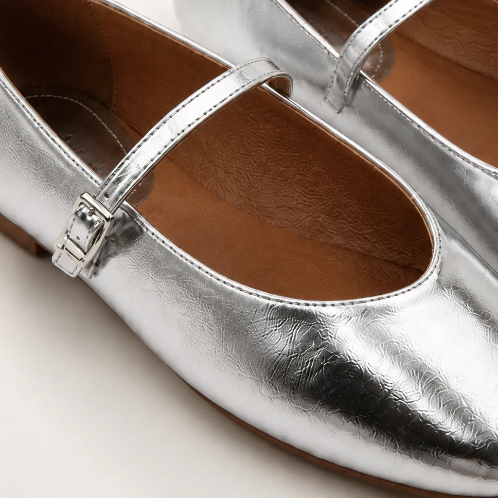 Close-up detail of the glossy Mary Jane flat finish and strap construction