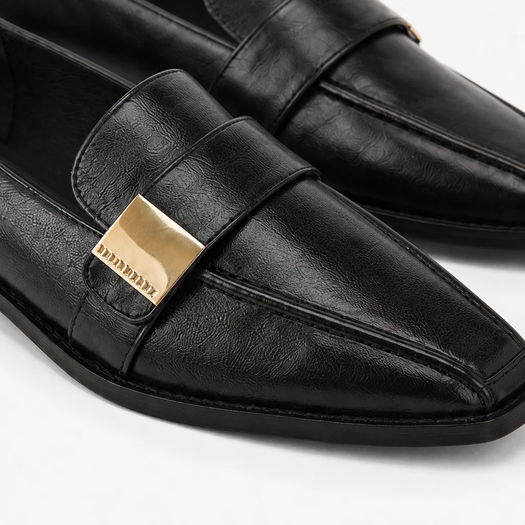 Close-up detail of the glossy upper and loafer construction